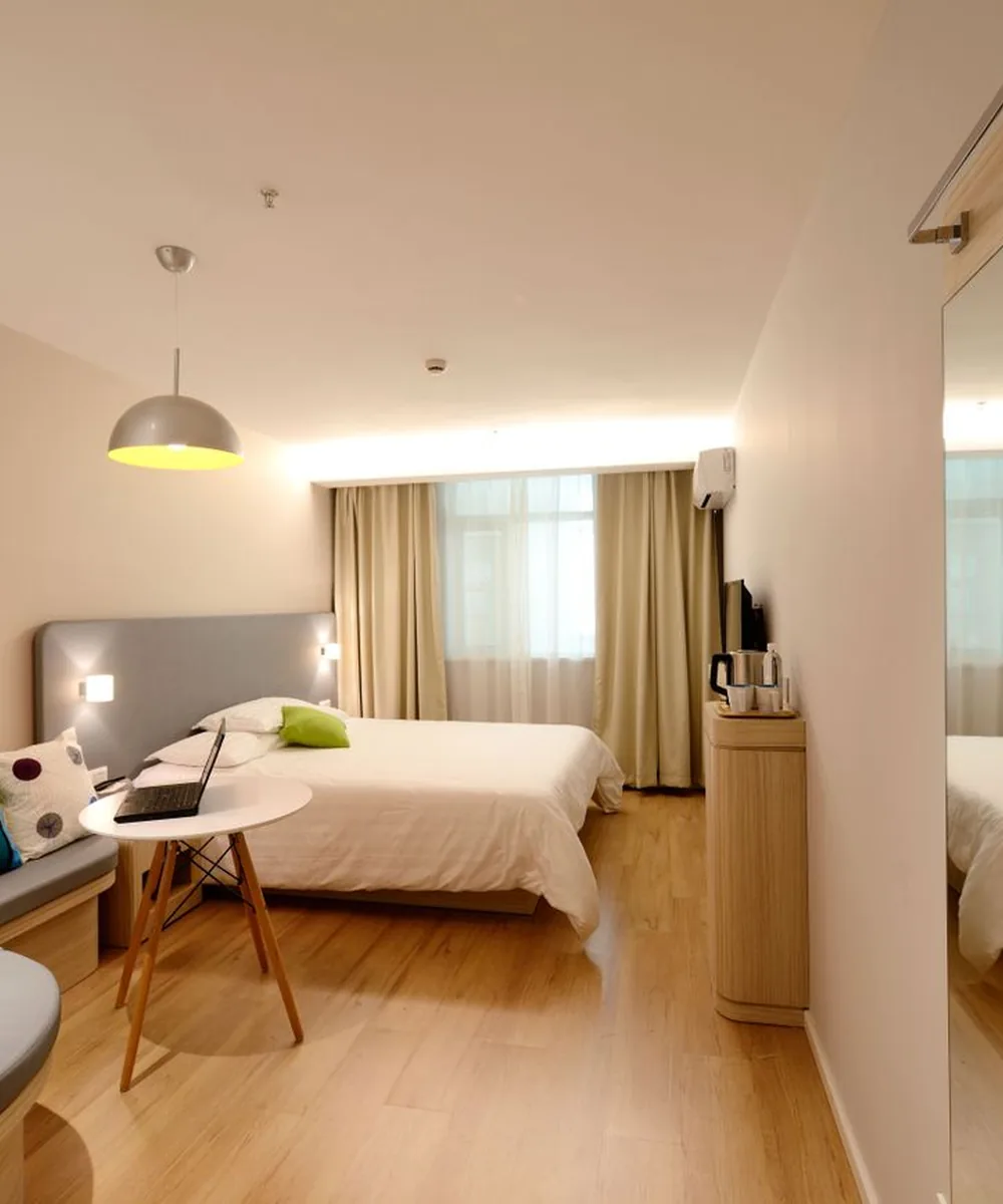 White bed linen in a calm, warmly lit hotel room